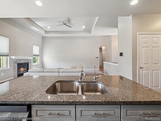 2655 Devondale Rd, Rochester Hills, MI 48309 - kitchen featuring open floor plan, ceiling fan, stone counters, a raised ceiling, and gray cabinets