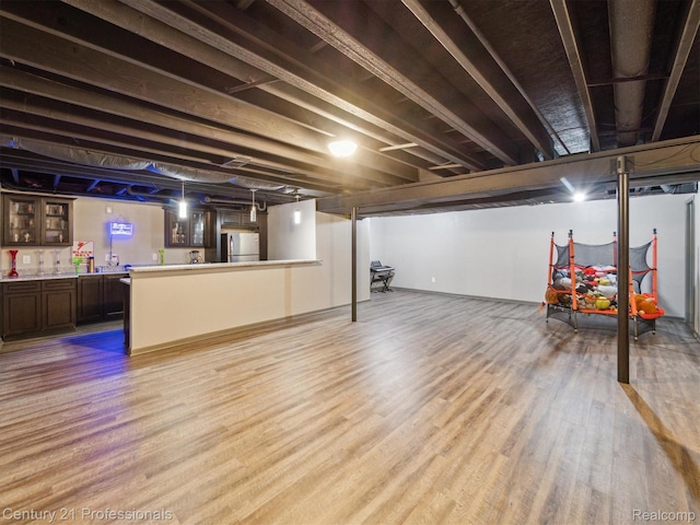 2655 Devondale Rd, Rochester Hills, MI 48309 - finished basement featuring freestanding refrigerator, wood finished floors, and a community bar