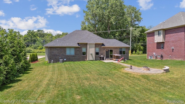 2655 Devondale Rd, Rochester Hills, MI 48309 - rear view of house featuring a fire pit, brick siding, a yard, and a patio