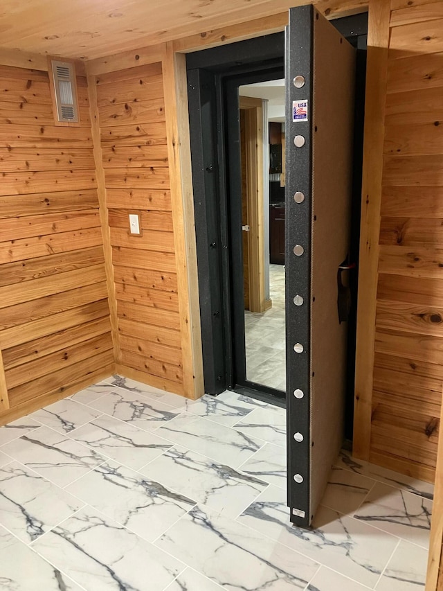 9434 84th St SE, Alto, MI 49302 - hallway featuring wooden walls and light marble finish flooring