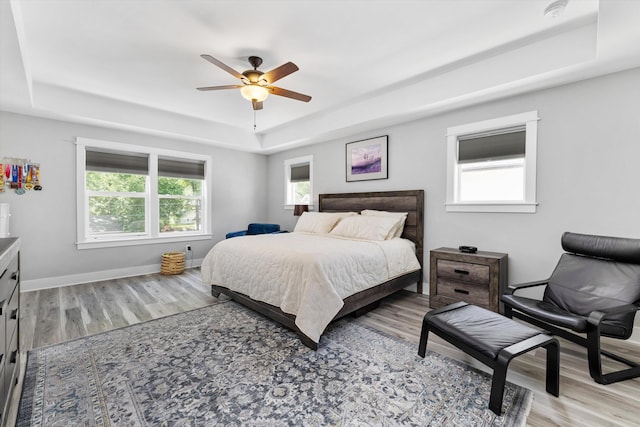 711 N Alexander Ave, Royal Oak, MI 48067 - bedroom featuring a raised ceiling, light wood-style floors, and a ceiling fan
