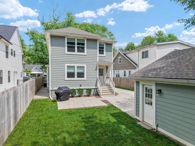 711 N Alexander Ave, Royal Oak, MI 48067 - rear view of house featuring a patio, a fenced backyard, and roof with shingles