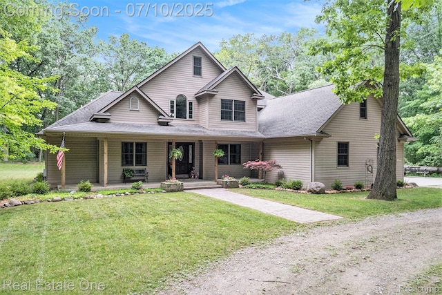 359 High Bluffs Dr, Ortonville, MI 48462 - view of front of home featuring a porch, roof with shingles, and a front lawn