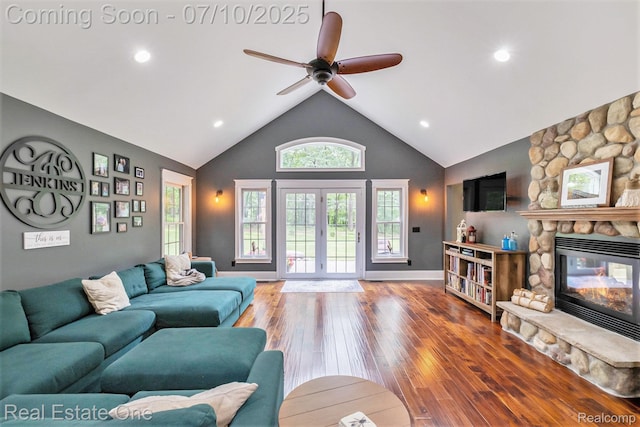 359 High Bluffs Dr, Ortonville, MI 48462 - living room with high vaulted ceiling, ceiling fan, a fireplace, french doors, and wood finished floors