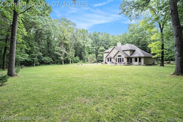 359 High Bluffs Dr, Ortonville, MI 48462 - view of green lawn featuring a wooded view