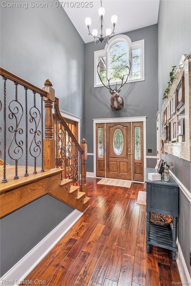 359 High Bluffs Dr, Ortonville, MI 48462 - entrance foyer featuring a high ceiling, wood-type flooring, a chandelier, and stairway