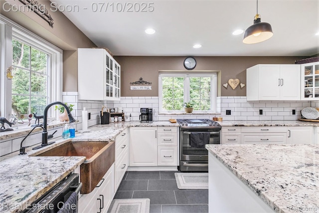 359 High Bluffs Dr, Ortonville, MI 48462 - kitchen with gas stove, light stone counters, backsplash, and recessed lighting