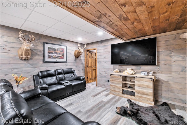 359 High Bluffs Dr, Ortonville, MI 48462 - living room featuring wooden walls, wood finished floors, and a drop ceiling