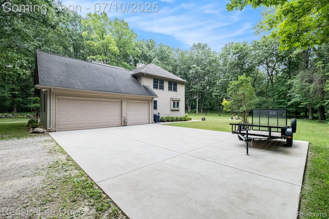 359 High Bluffs Dr, Ortonville, MI 48462 - colonial home with a front yard, an attached garage, concrete driveway, roof with shingles, and view of wooded area