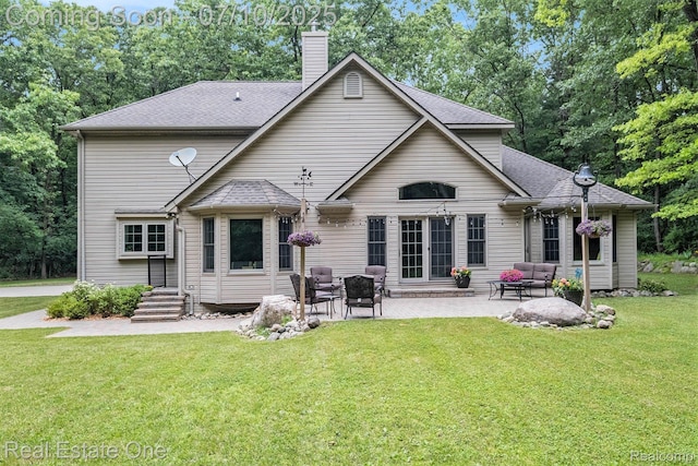 359 High Bluffs Dr, Ortonville, MI 48462 - rear view of property with a chimney, a lawn, a patio, roof with shingles, and outdoor lounge area