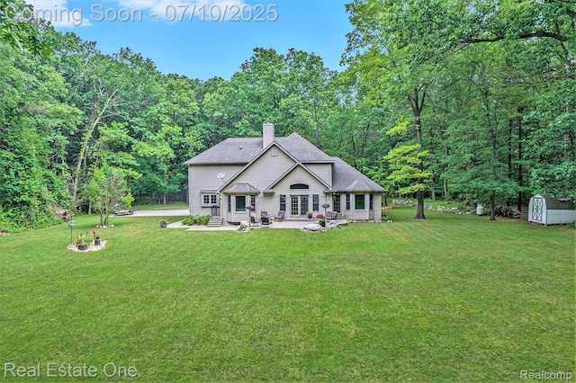 359 High Bluffs Dr, Ortonville, MI 48462 - rear view of house with a chimney, a shed, a patio area, and a yard