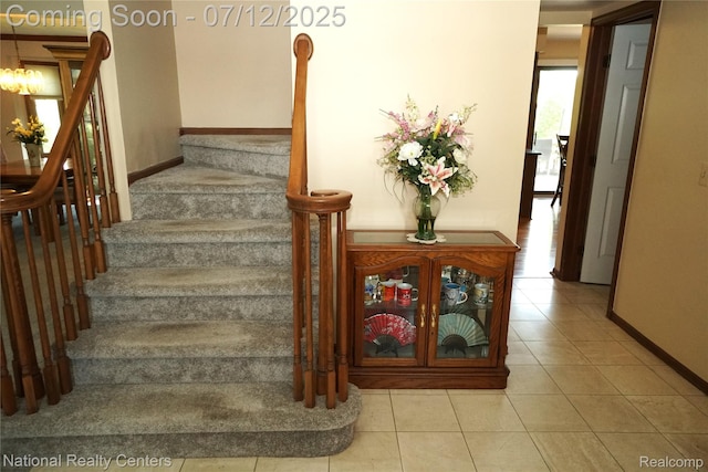 19230 Augusta Ct, Livonia, MI 48152 - stairs featuring tile patterned floors and a chandelier