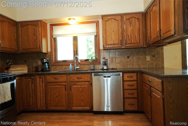 19230 Augusta Ct, Livonia, MI 48152 - kitchen featuring stainless steel appliances, brown cabinetry, light wood-style floors, and backsplash