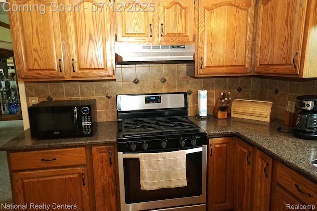 19230 Augusta Ct, Livonia, MI 48152 - kitchen with stainless steel gas range, under cabinet range hood, black microwave, decorative backsplash, and brown cabinets