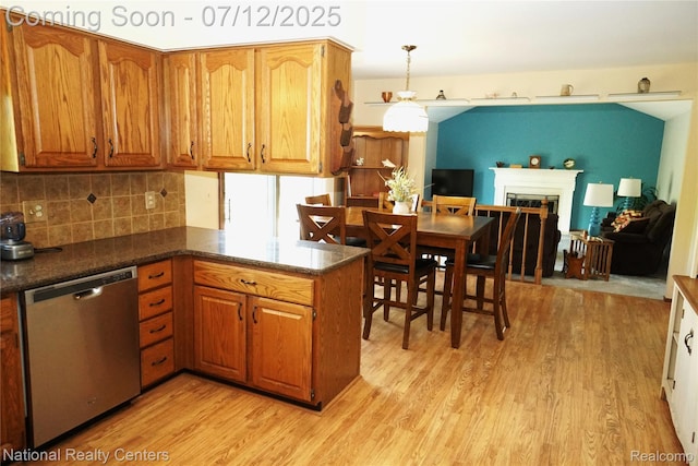 19230 Augusta Ct, Livonia, MI 48152 - kitchen with stainless steel dishwasher, light wood-type flooring, and brown cabinetry