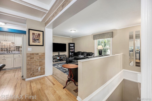 38683 Bayside Ct Unit 118, Clinton Township, MI 48038 - hallway featuring an upstairs landing, light wood-style floors, crown molding, and wainscoting