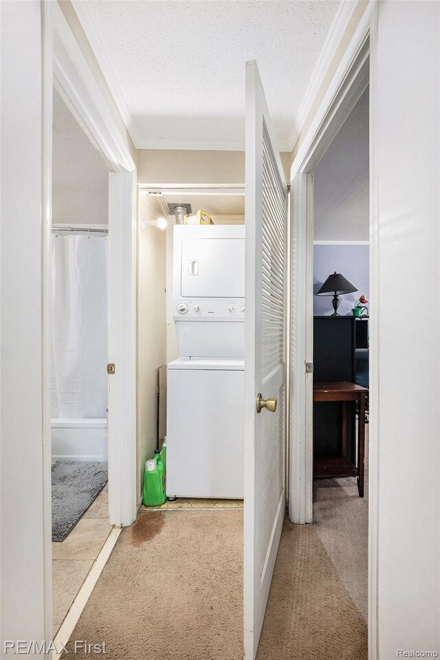 38683 Bayside Ct Unit 118, Clinton Township, MI 48038 - hall with stacked washer / dryer, carpet flooring, crown molding, and a textured ceiling