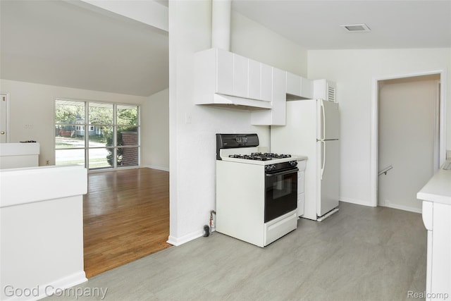 2931 N Main St, Royal Oak, MI 48073 - kitchen with white appliances, lofted ceiling, white cabinetry, light countertops, and light wood-style flooring