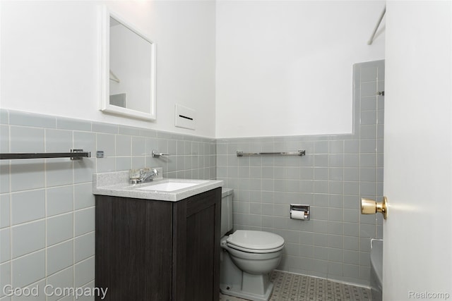 2931 N Main St, Royal Oak, MI 48073 - bathroom with tile walls, vanity, a wainscoted wall, and tile patterned flooring