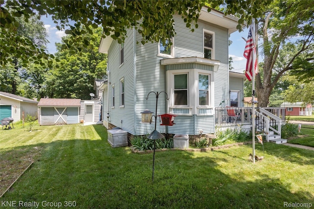 204 W Caroline St, Bellevue, MI 49021 - view of front of home with a storage unit, a front lawn, and a detached garage