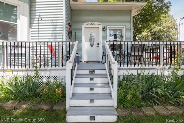 204 W Caroline St, Bellevue, MI 49021 - view of exterior entry featuring a porch