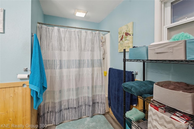 204 W Caroline St, Bellevue, MI 49021 - full bathroom featuring a shower with shower curtain and a wainscoted wall