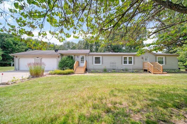 8756 Portage Lake Rd, Munith, MI 49259 - ranch-style home with a garage, driveway, and a front lawn