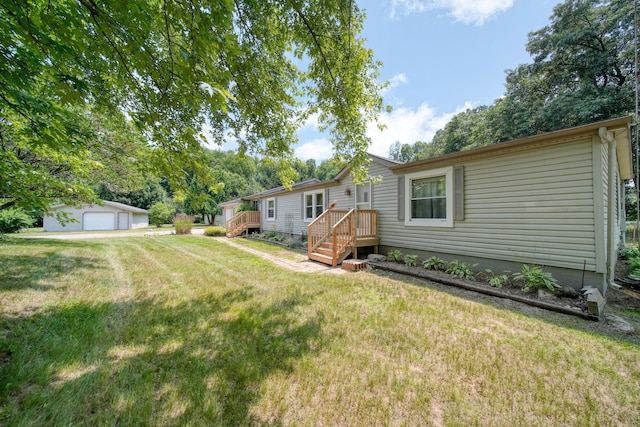 8756 Portage Lake Rd, Munith, MI 49259 - view of grassy yard featuring a detached garage and an outdoor structure