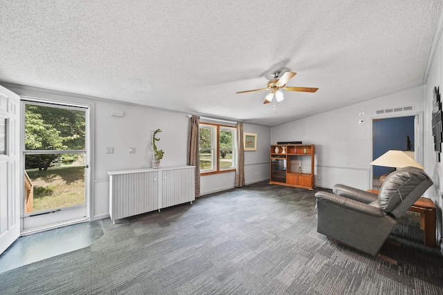 8756 Portage Lake Rd, Munith, MI 49259 - living area featuring ceiling fan, healthy amount of natural light, lofted ceiling, and a textured ceiling