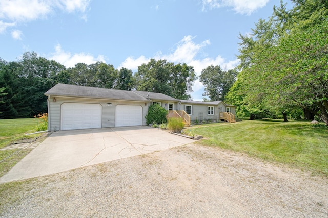 8756 Portage Lake Rd, Munith, MI 49259 - single story home with driveway, a garage, and a front lawn