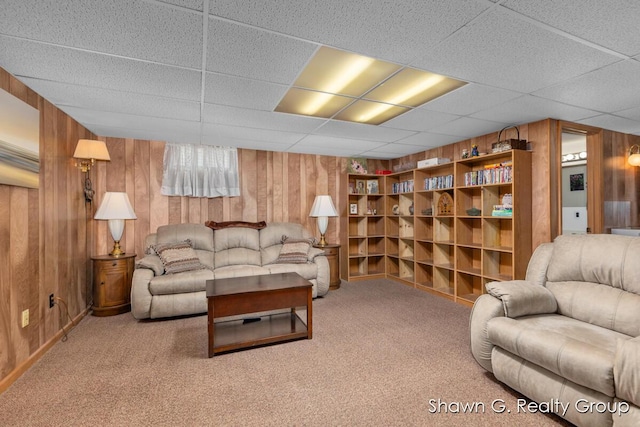 1060 Village Ln, Jenison, MI 49428 - carpeted living room with wooden walls and a drop ceiling