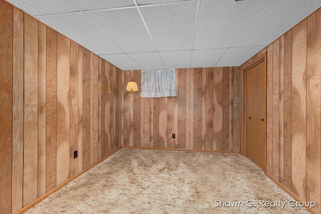 1060 Village Ln, Jenison, MI 49428 - carpeted empty room featuring wooden walls and a drop ceiling