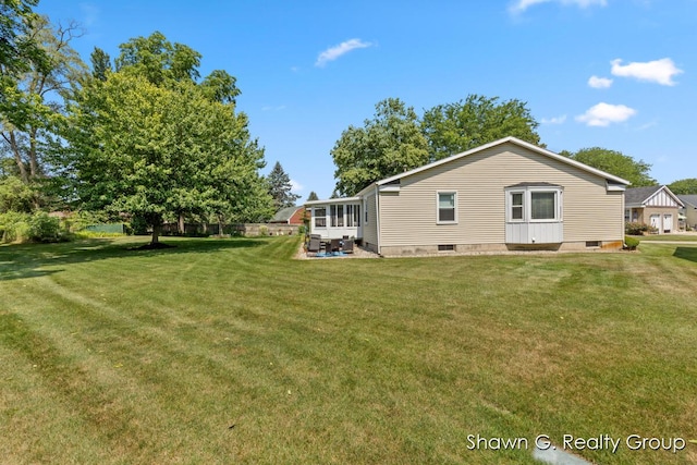 1060 Village Ln, Jenison, MI 49428 - rear view of house featuring a lawn and a patio area