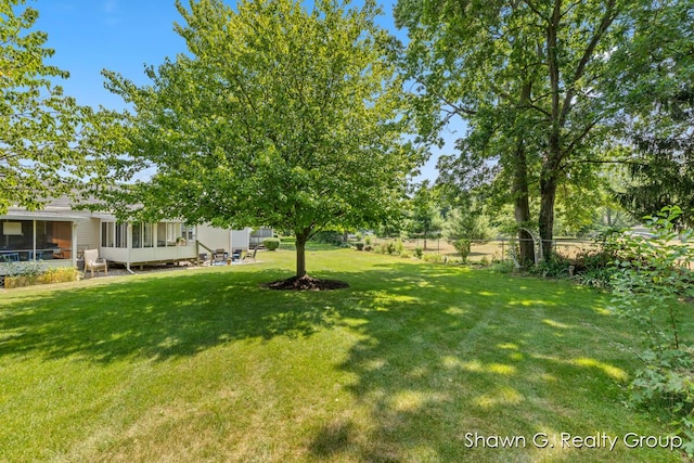 1060 Village Ln, Jenison, MI 49428 - view of yard featuring a sunroom