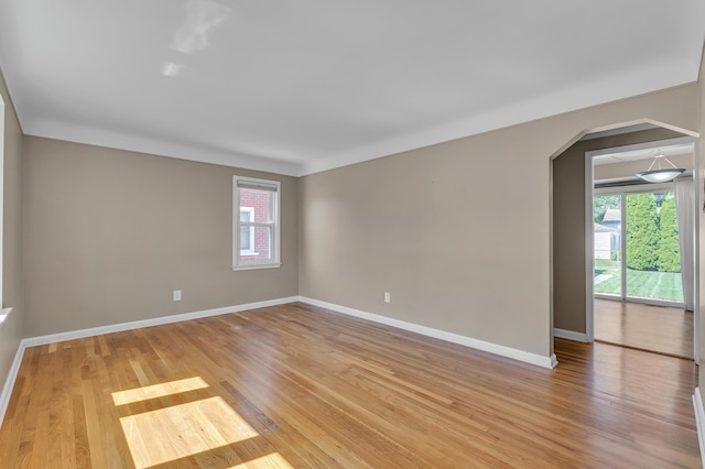 9623 Fairfield St, Livonia, MI 48150 - spare room featuring plenty of natural light, arched walkways, and light wood-style floors