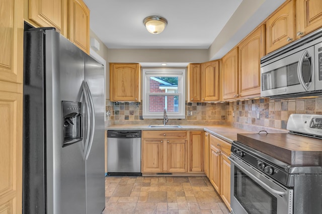 9623 Fairfield St, Livonia, MI 48150 - kitchen with appliances with stainless steel finishes, decorative backsplash, light countertops, and light stone finish flooring