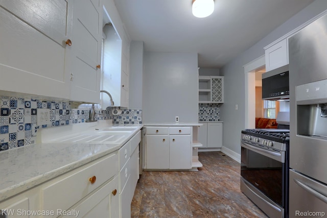1828 N Lafayette Ave, Royal Oak, MI 48073 - kitchen with stainless steel appliances, white cabinetry, decorative backsplash, open shelves, and light stone counters