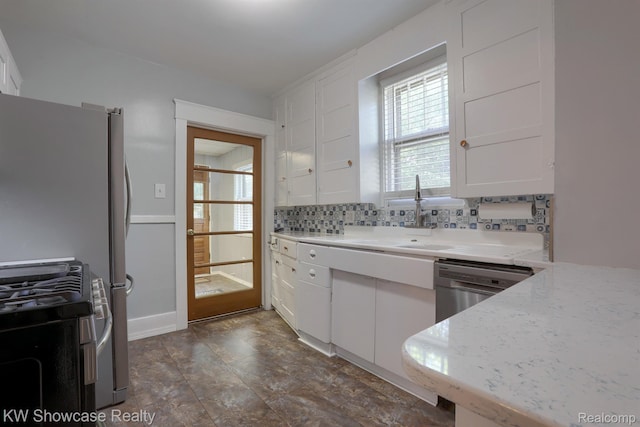 1828 N Lafayette Ave, Royal Oak, MI 48073 - kitchen featuring white cabinetry, appliances with stainless steel finishes, backsplash, and light stone countertops