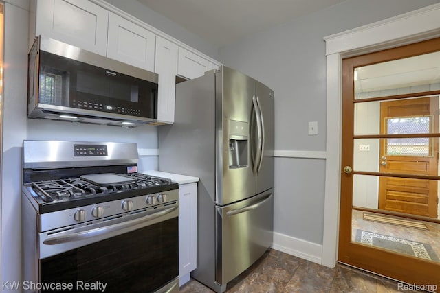 1828 N Lafayette Ave, Royal Oak, MI 48073 - kitchen with appliances with stainless steel finishes, white cabinetry, light countertops, and dark stone finish flooring