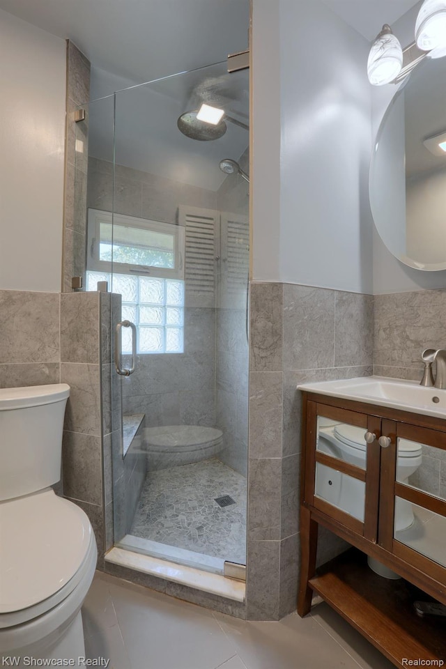 1828 N Lafayette Ave, Royal Oak, MI 48073 - full bath with tile walls, a shower stall, vanity, a wainscoted wall, and tile patterned flooring