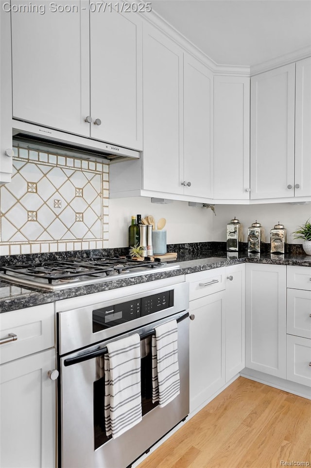 425 Fairfax St, Birmingham, MI 48009 - kitchen with appliances with stainless steel finishes, exhaust hood, white cabinets, and light wood-style floors