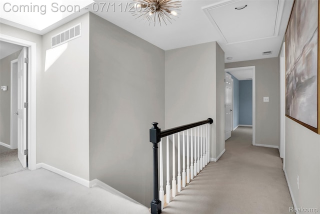 425 Fairfax St, Birmingham, MI 48009 - corridor with light carpet, an upstairs landing, and attic access