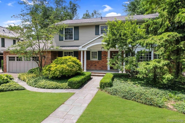 425 Fairfax St, Birmingham, MI 48009 - view of front of property featuring brick siding, a front yard, a porch, and a garage