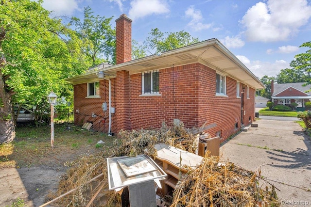 19155 Gallagher St, Detroit, MI 48234 - view of property exterior featuring a chimney and brick siding