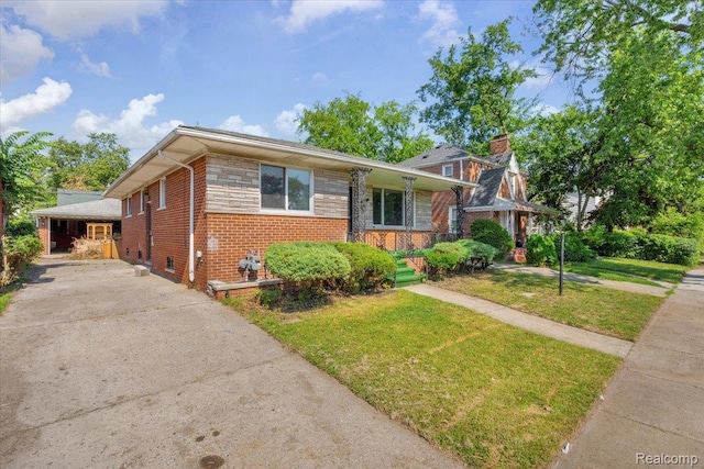 19155 Gallagher St, Detroit, MI 48234 - view of front of property with a front lawn, brick siding, concrete driveway, and a chimney