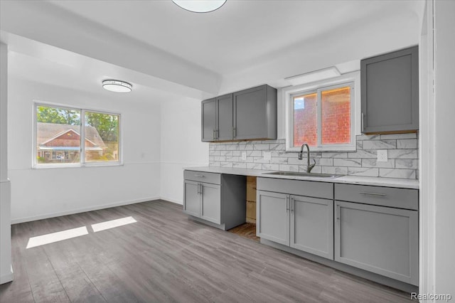 19155 Gallagher St, Detroit, MI 48234 - kitchen with gray cabinetry, decorative backsplash, and light wood-type flooring