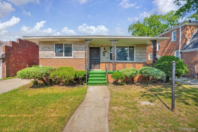19155 Gallagher St, Detroit, MI 48234 - view of front of property with covered porch, a front lawn, stone siding, and brick siding