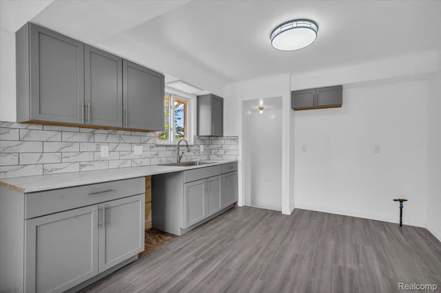 19155 Gallagher St, Detroit, MI 48234 - kitchen with gray cabinets, light wood-style floors, tasteful backsplash, and light countertops