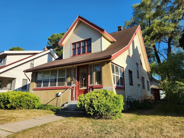 1110 Watkins St SE, Grand Rapids, MI 49507 - view of front of house with a chimney, a front yard, stucco siding, and a shingled roof