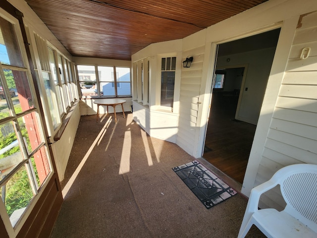 1110 Watkins St SE, Grand Rapids, MI 49507 - unfurnished sunroom featuring wooden ceiling and carpet flooring